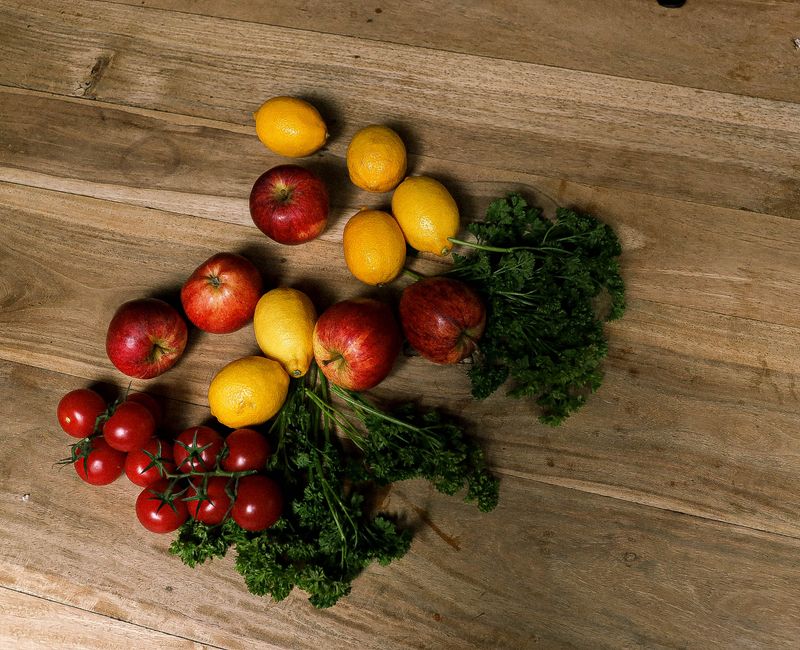 A vibrant display of seasonal Moroccan ingredients on a rustic wooden table.