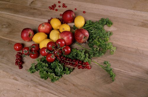 Red and Yellow Round Fruits on Brown Wooden Table