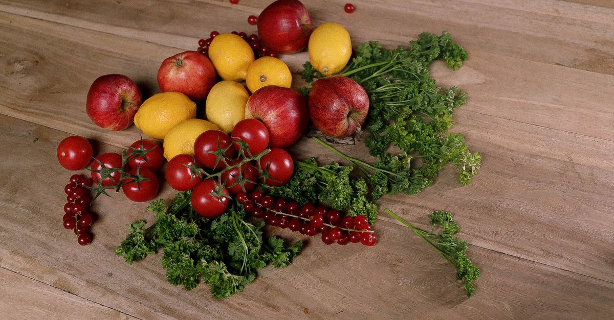 colorful array of fruits vegetables on wooden table