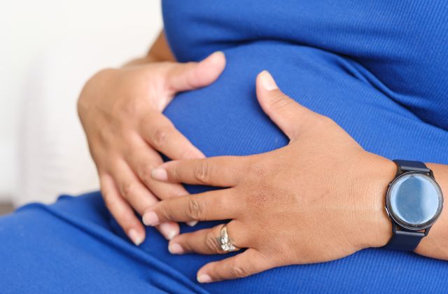Pregnant woman with hands on her belly