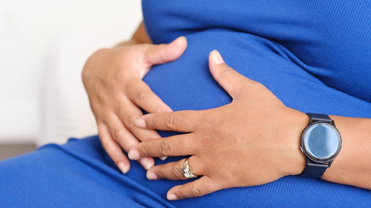 Pregnant woman holding her belly