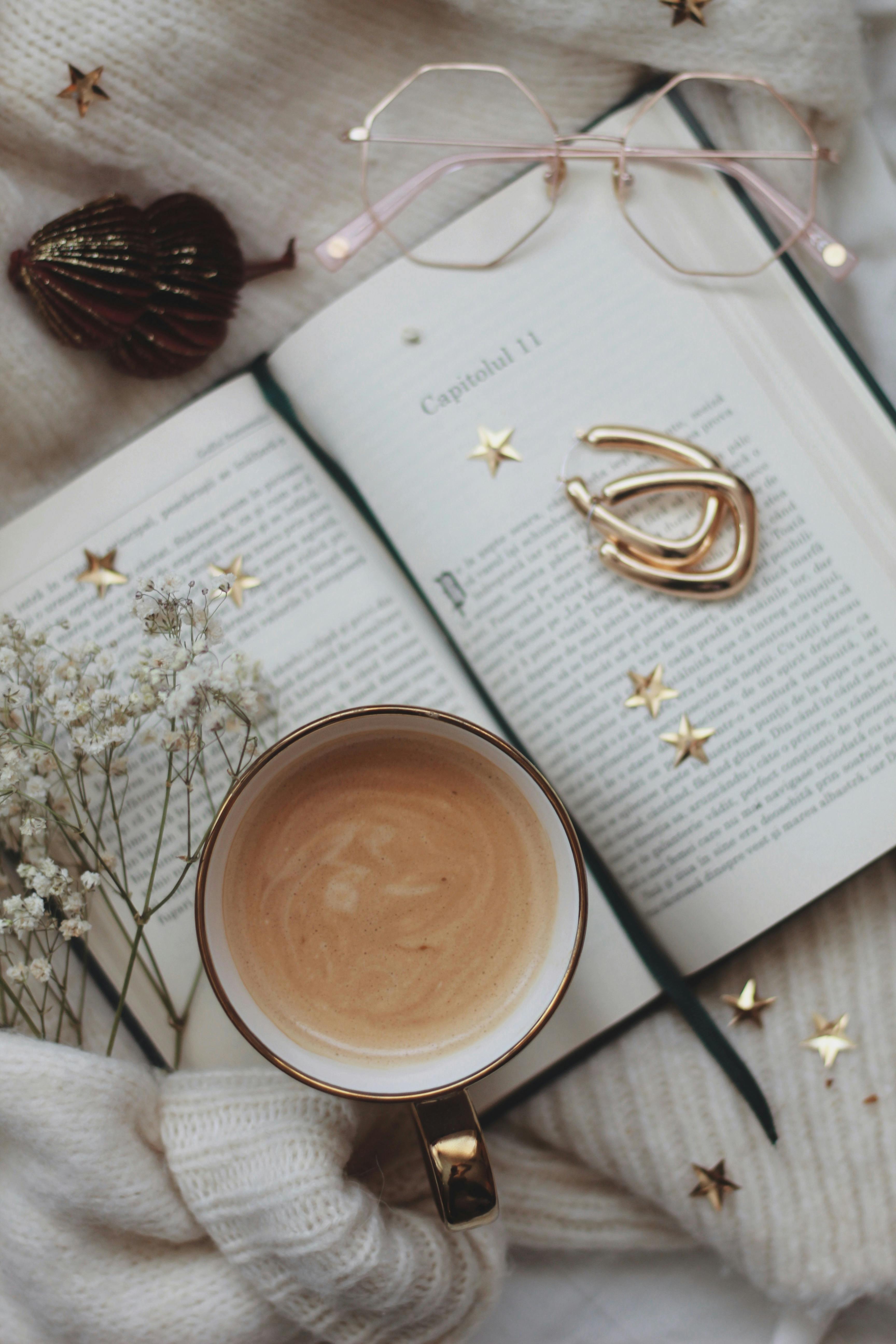 sunglasses and coffee mug on an open book