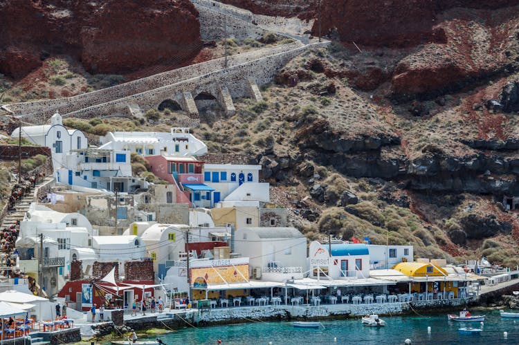 White And Blue Houses Beside Body Of Water