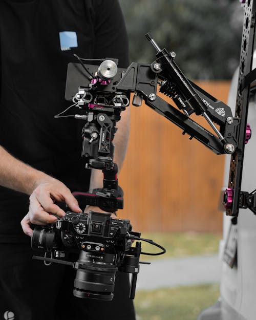 A Person Holding Black Video Camera