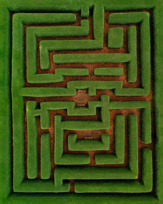 Discover the intricate green hedge maze pattern from above, located in Australia.