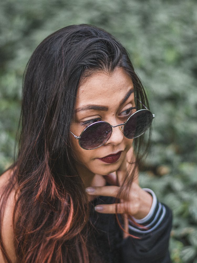 Woman Wearing Round Sunglasses With Long Hair