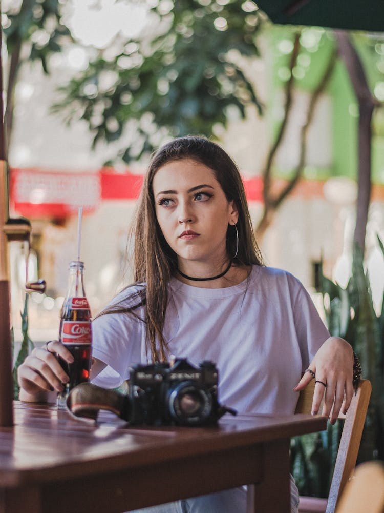 Woman Sitting With Cola And Camera