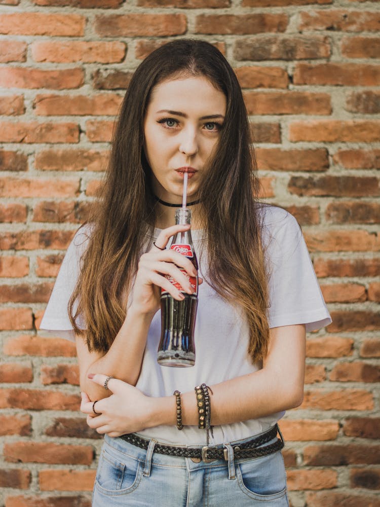 Woman Drinking Coke From Bottle