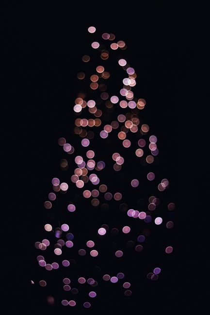 Artistic bokeh light pattern creating a tree shape on a dark background.