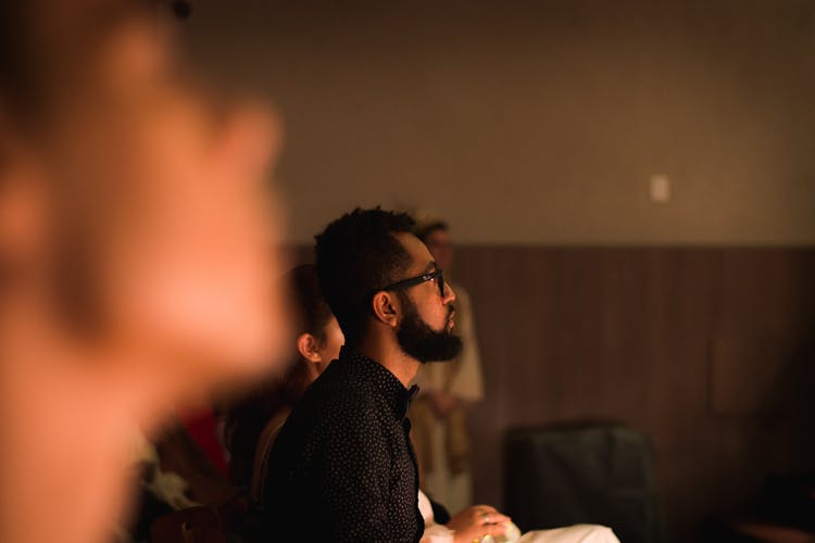 Side View Of A Man With Beard Listening In A Forum