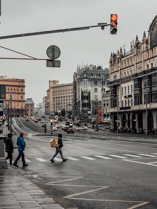 People Crossing the Street in a City