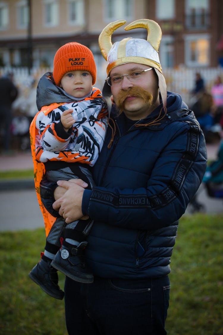 Father Holding Son On Hand