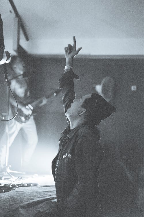 Black and White Photo of a Man at a Concert 