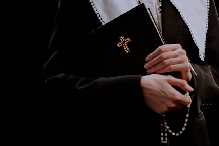 A Nun Holding A Holy Bible