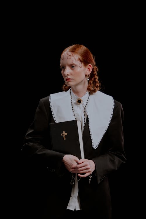 Elegant Redhead Model Posing with Bible