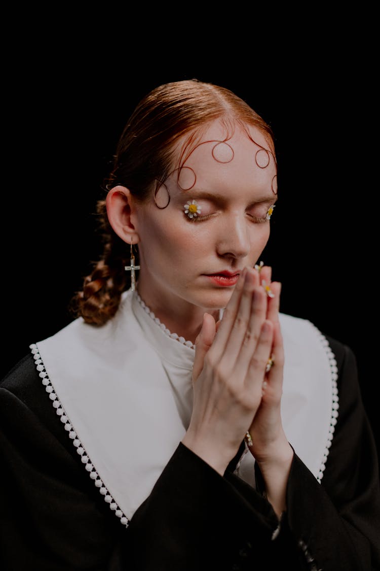 Woman In Black Long Sleeves Praying Solemnly