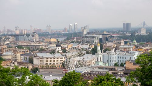 Free Panoramic aerial view of Kyiv, showcasing a Ferris wheel and iconic cityscape. Stock Photo