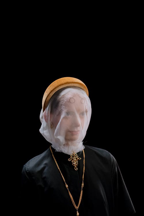 Woman Posing in Black Dress and White Veil with Brown Headband