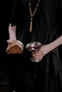 A Person Holding a Bread and Wine
