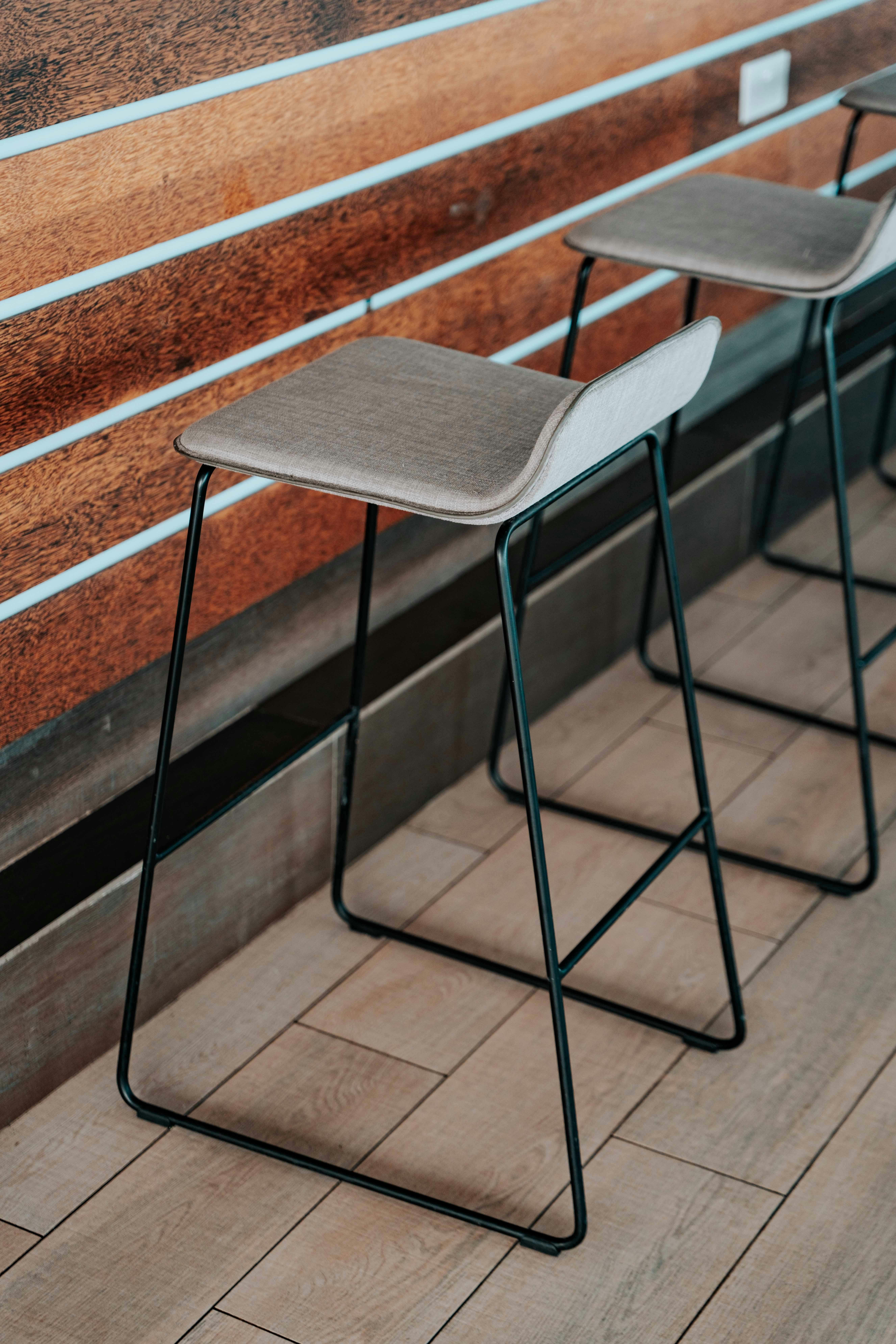 Stylish bar stools with a modern design in a bright interior setting, perfect for lifestyle themes.
