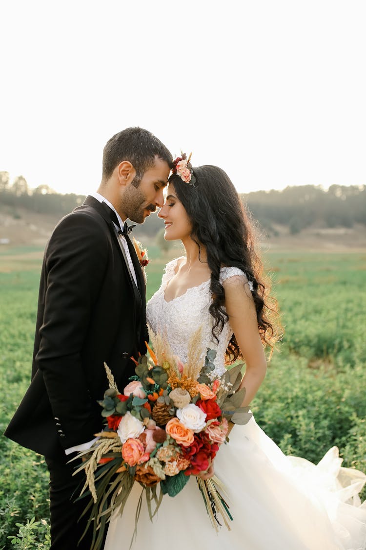 Portrait Of Bride And Groom In Field