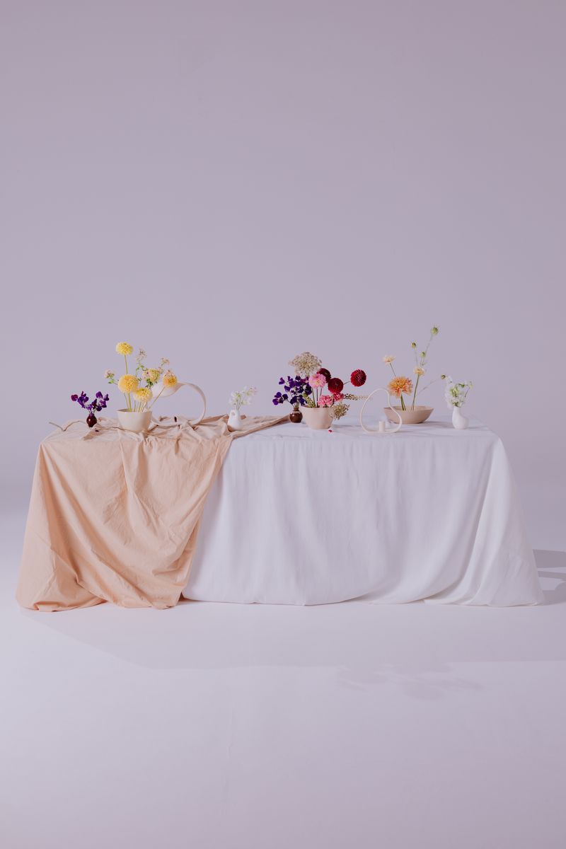 A beautifully set dinner table with candles and floral centrepiece