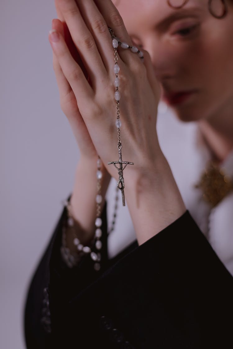 A Woman Holding A Rosary