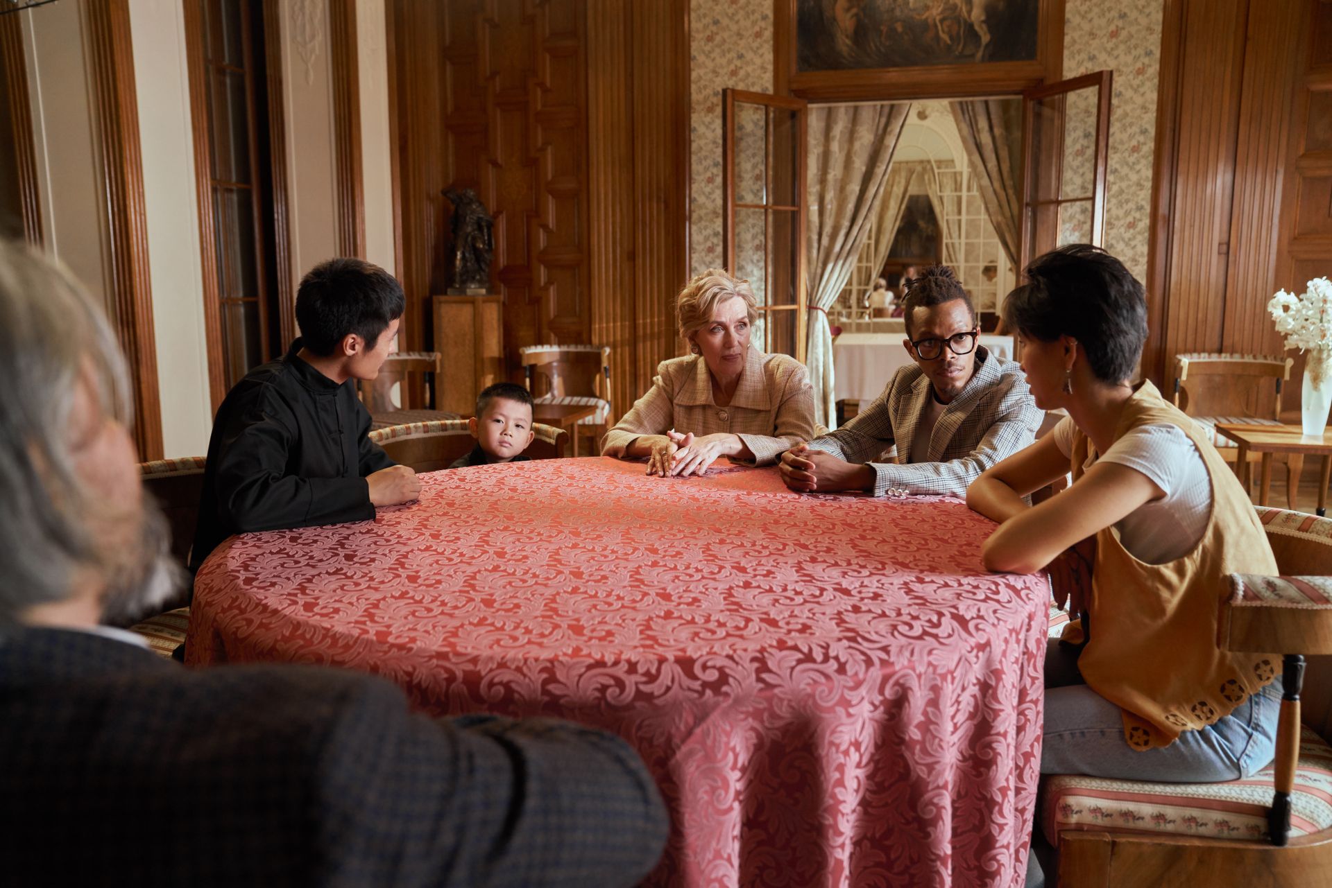 Family Sitting Together at Round Table and Talking