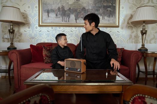 Father and Son in Home Interior Looking at Each Other with Happiness 