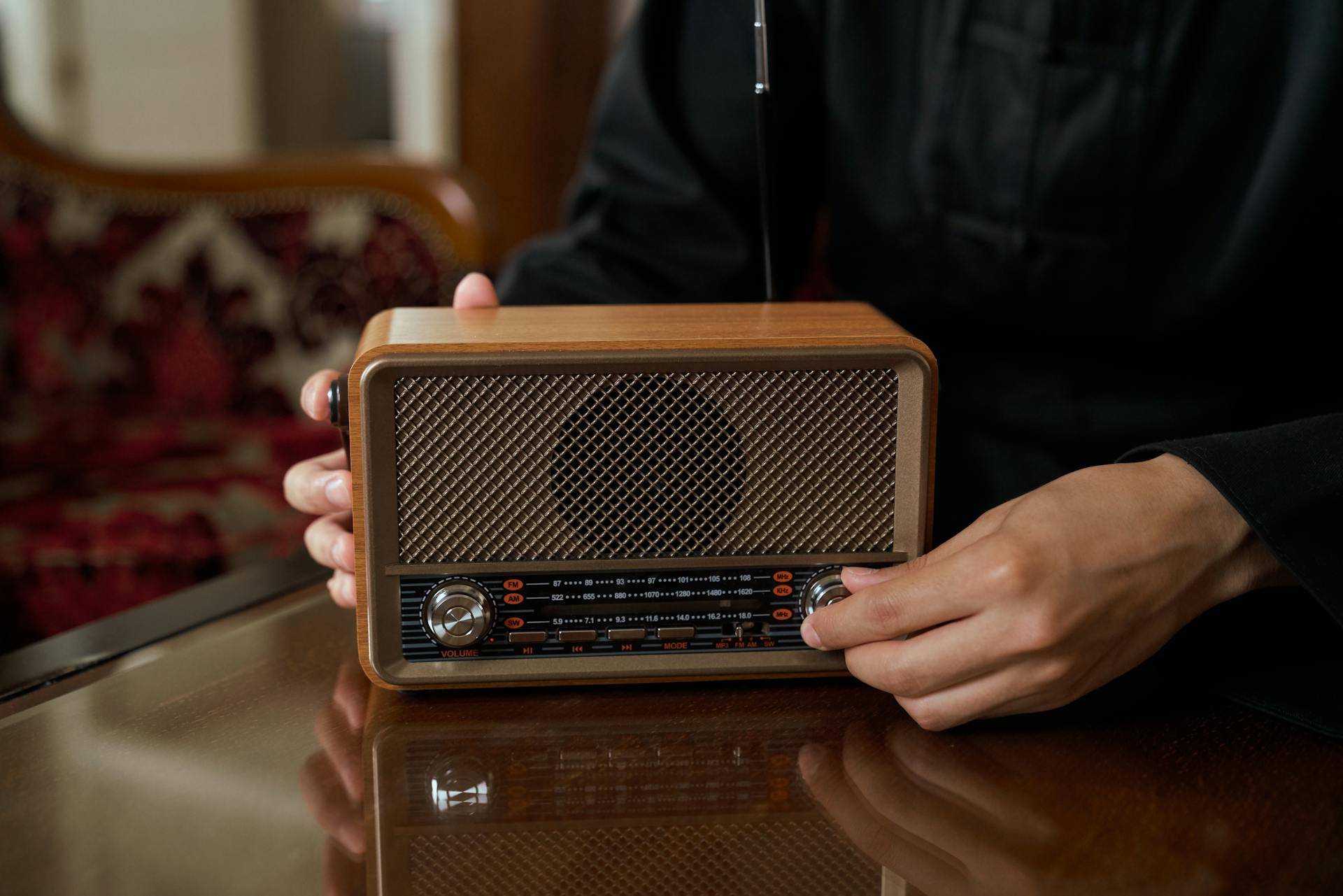 Unrecognizable Male Hand Putting Up Volume on Transistor Radio