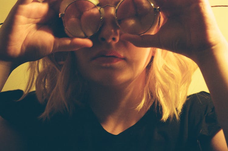 Woman Looking In Round Glasses