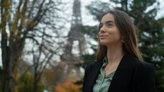 Woman in Black Blazer Standing Near Bare Trees