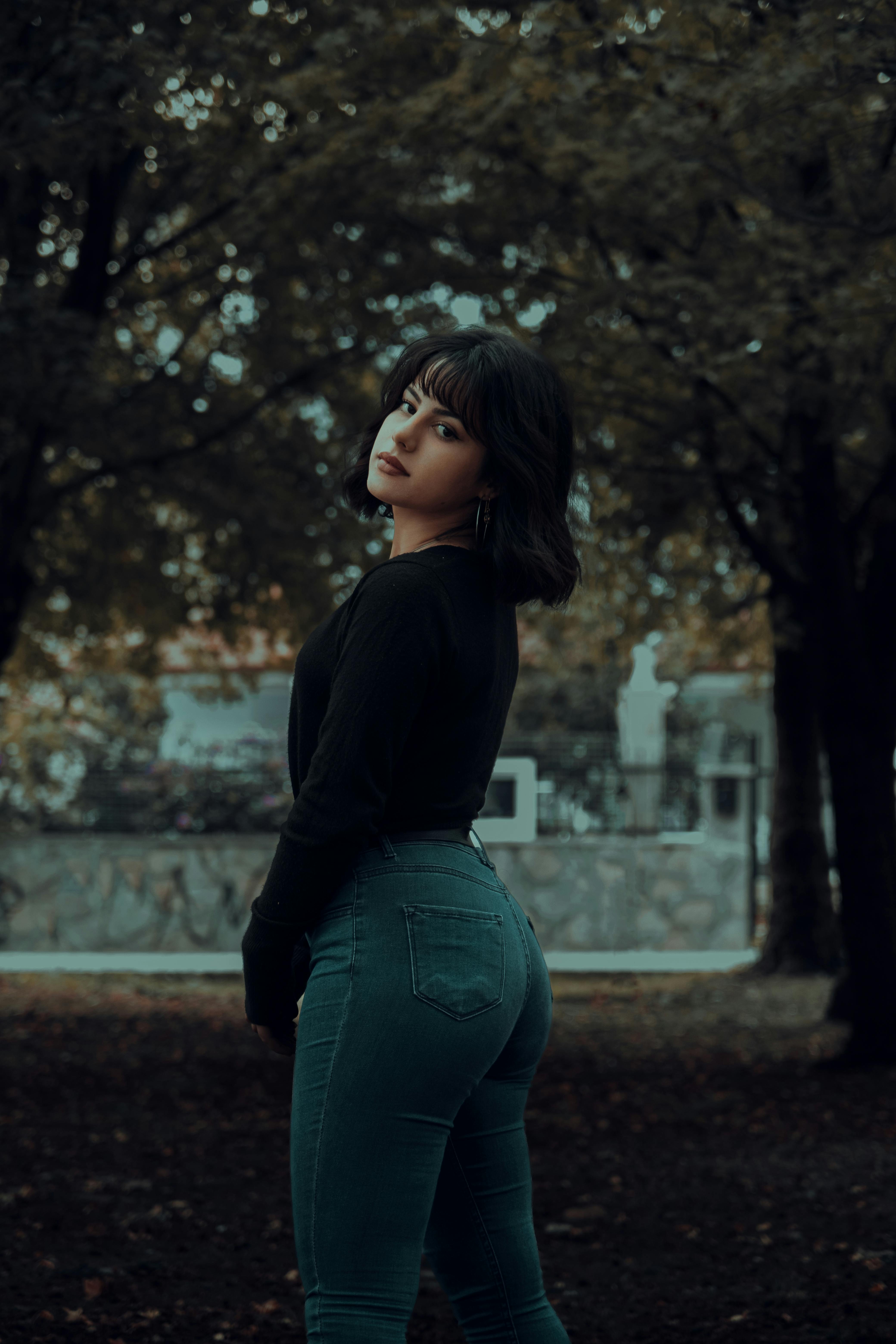 Woman in Denim Jumper Sitting on Bench · Free Stock Photo