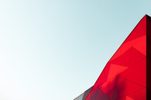 Free Low Angle Photo of a Red Textured Building Exterior Stock Photo