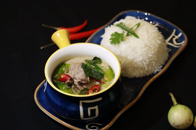 A Bowl Of Meat And Soup And White Rice On A Tray