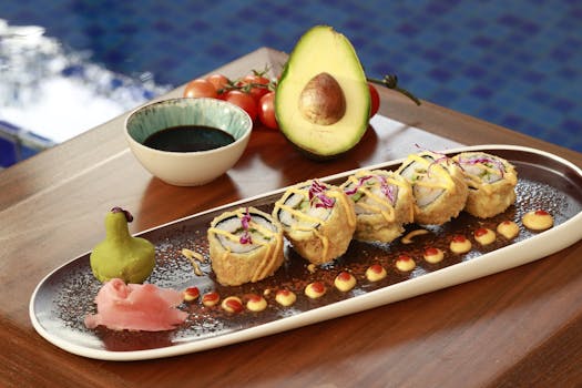 A beautifully presented sushi roll dish with avocado, wasabi, and soy sauce by a poolside setting.