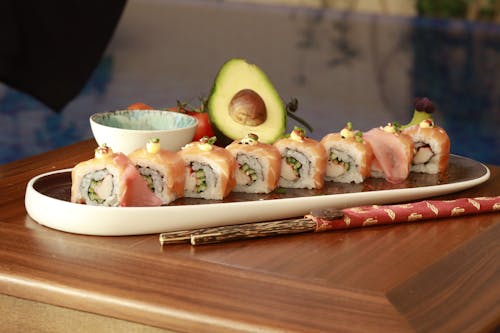 A Delicious Maki Sushi with Salmon on a White and Brown Serving Dish
