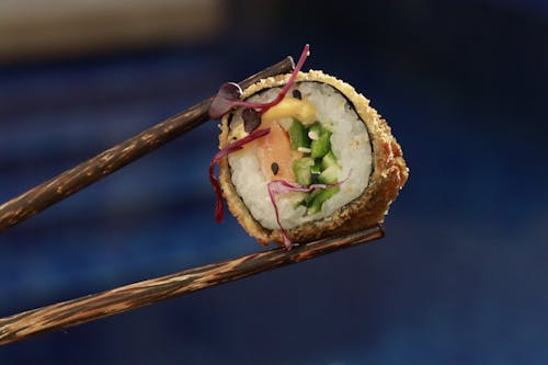 Sushi Roll Between Chopsticks