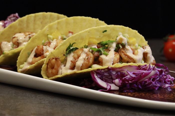 Crispy shrimp tacos with creamy sauce and slaw