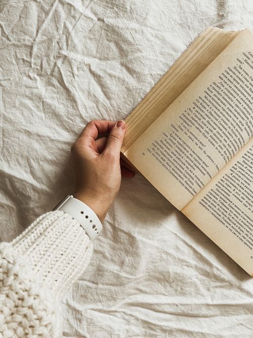Free A cozy close-up of a person turning pages of a book indoors, Estonia. Stock Photo