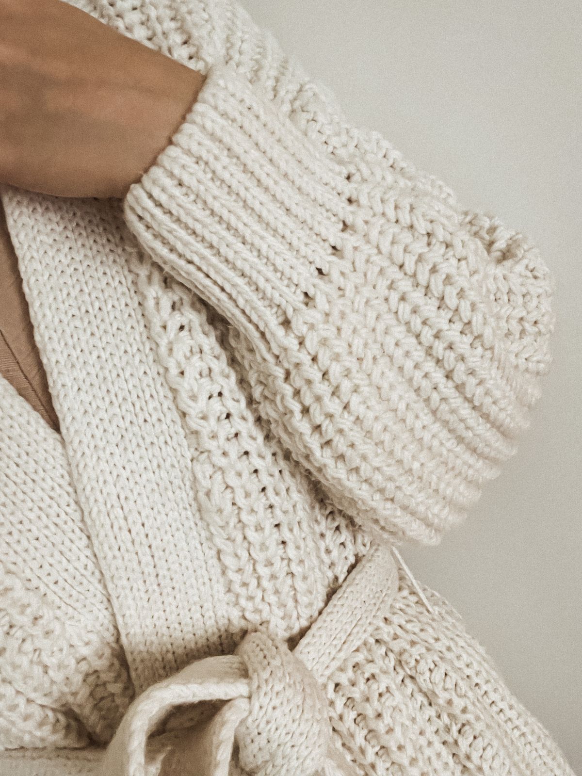 Editorial fashion image illustrating soft white knitted sweater styling