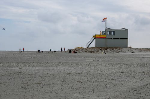 Free Lifeguard Post and People on Beach Sand  Stock Photo
