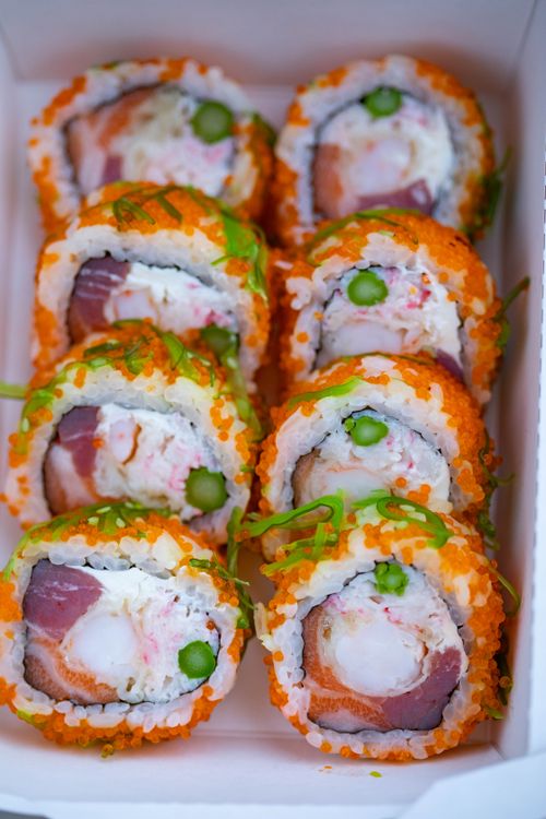 Free Vibrant sushi rolls with roe, surimi, and rich ingredients in takeout box. Stock Photo