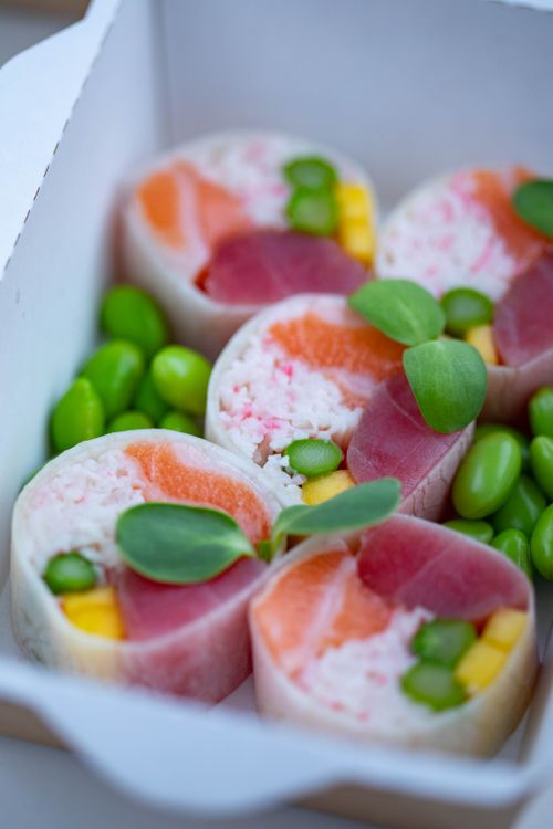 Free Colorful sushi rolls with salmon and tuna accompanied by edamame beans. Stock Photo