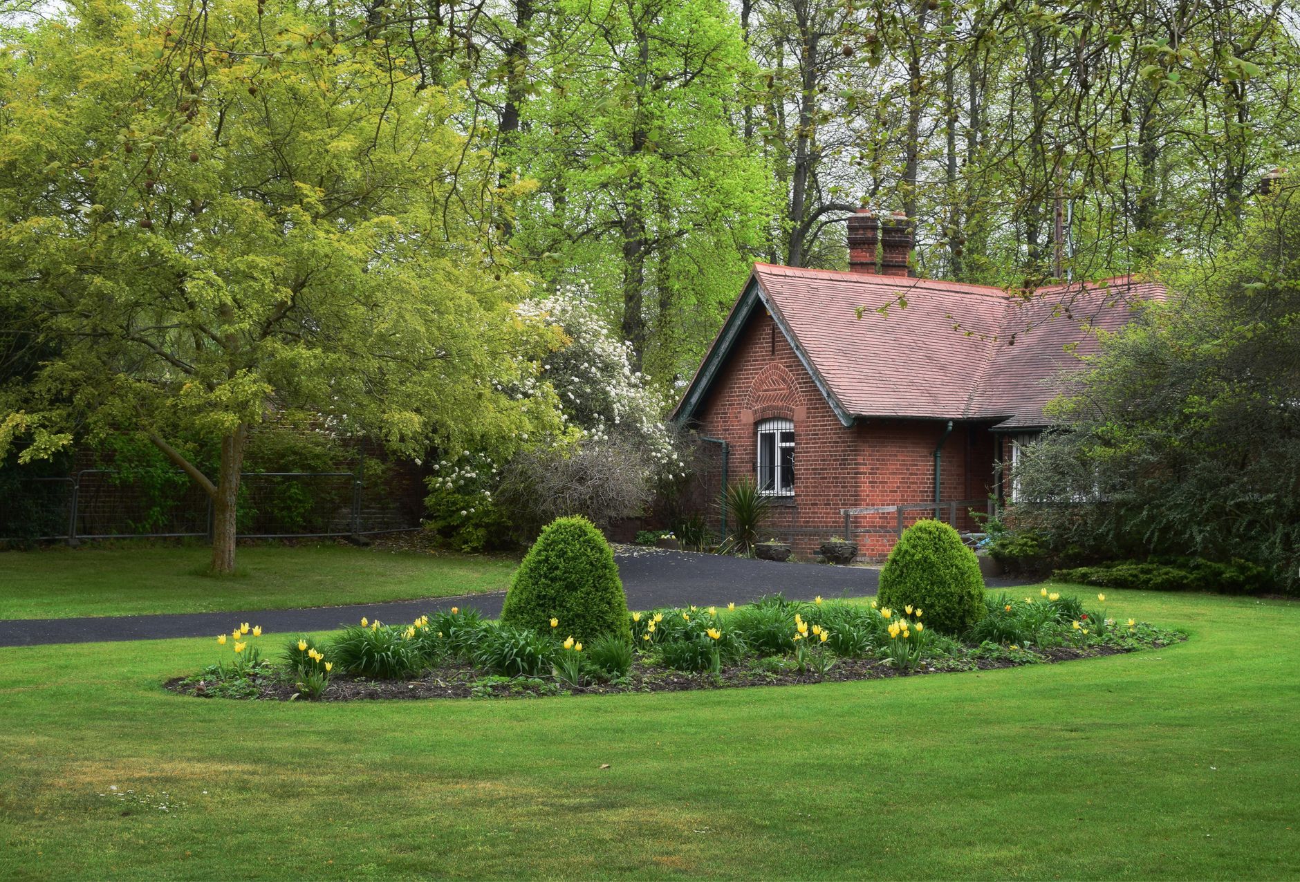 Brick cottage surrounded by a green garden in Dartford