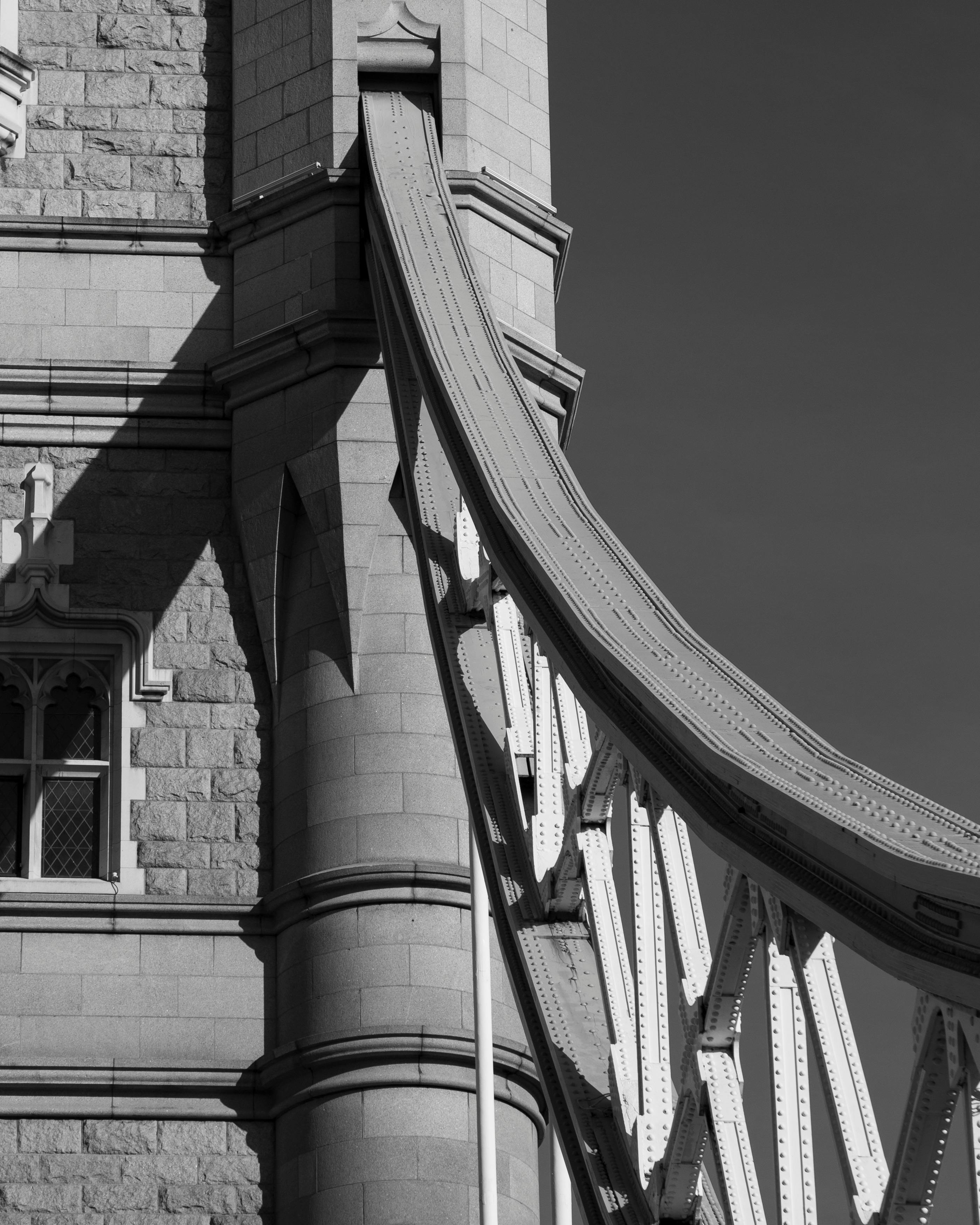 Close-up of a historic tower's architectural design in monochrome.