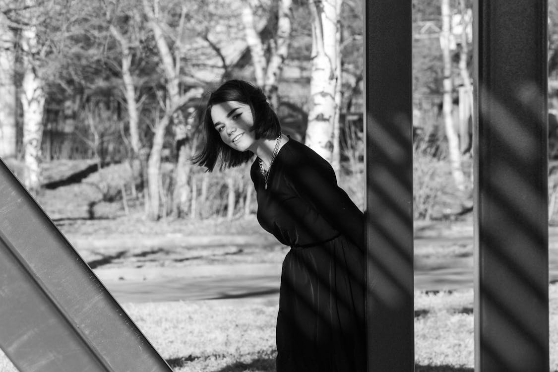 A Woman Smiling while Wearing Black Dress