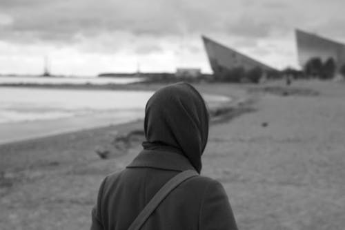 A Grayscale Photo of Person in Hoodie Jacket