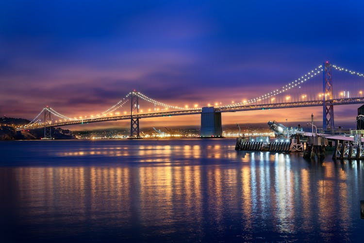 Bridge Over Water During Night Time