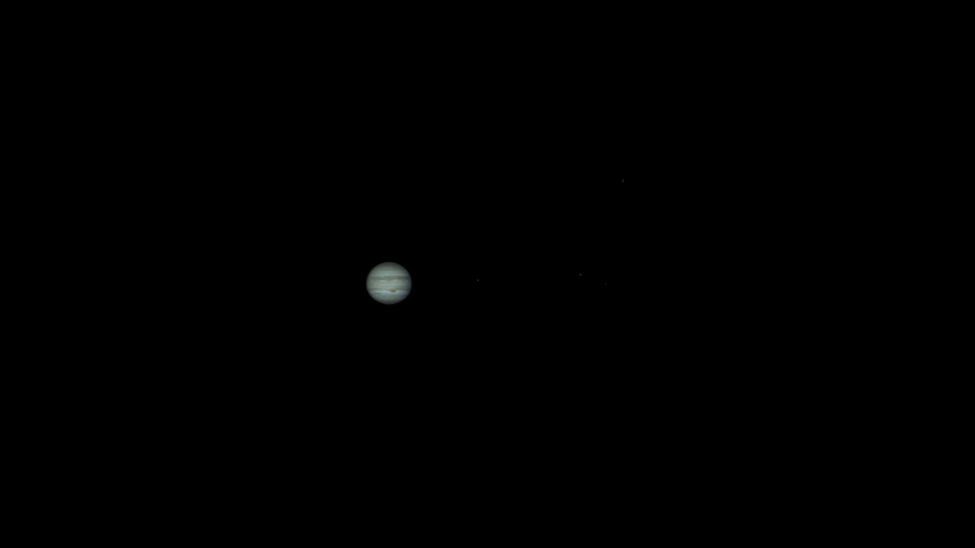 Capture of Jupiter with visible cloud bands against a dark sky.